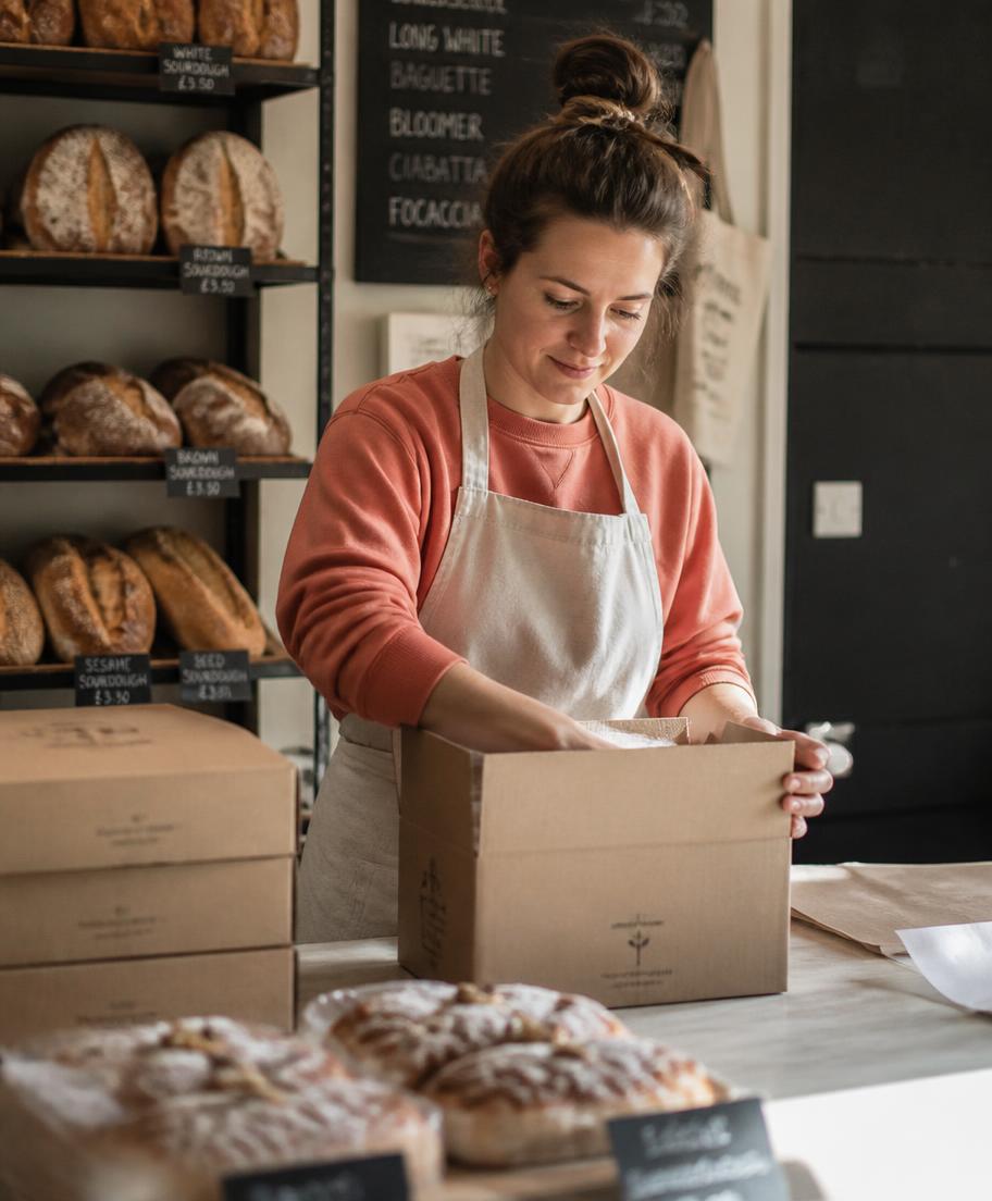 Bakery owner packing an order behind the counter